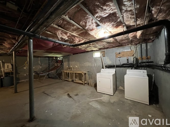 A room with a red ceiling and a white washing machine.