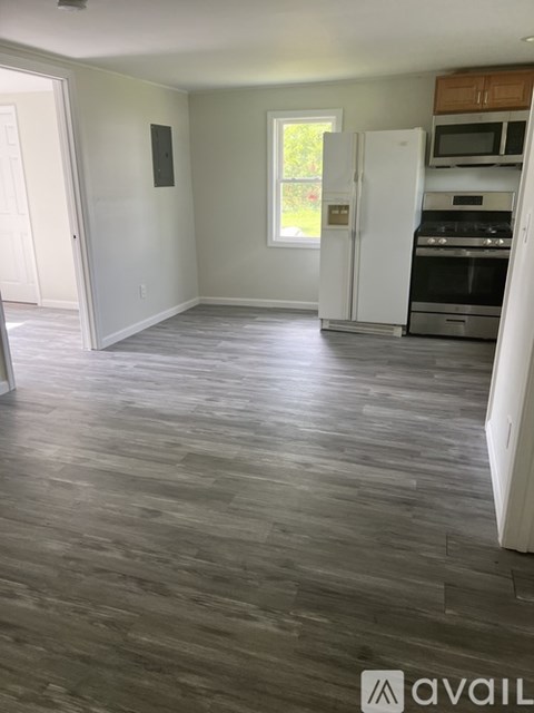 A kitchen with a white fridge and stove top oven.
