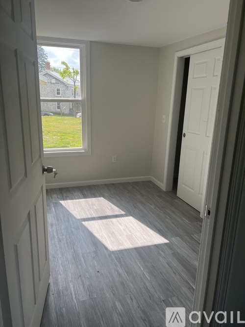 A room with a window and a door.