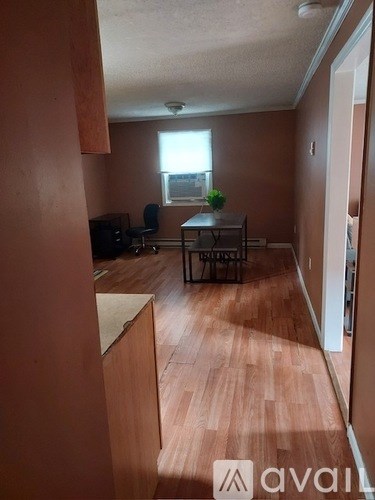 A living room with a brown floor and a brown wall.