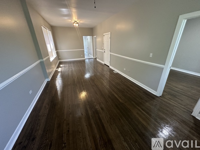 A room with wooden floors and white walls.