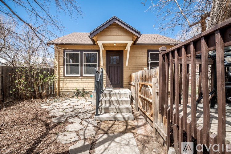 A house with a brown door and a brown fence.