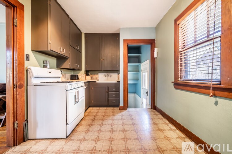 A kitchen with a white fridge and a brown counter top.