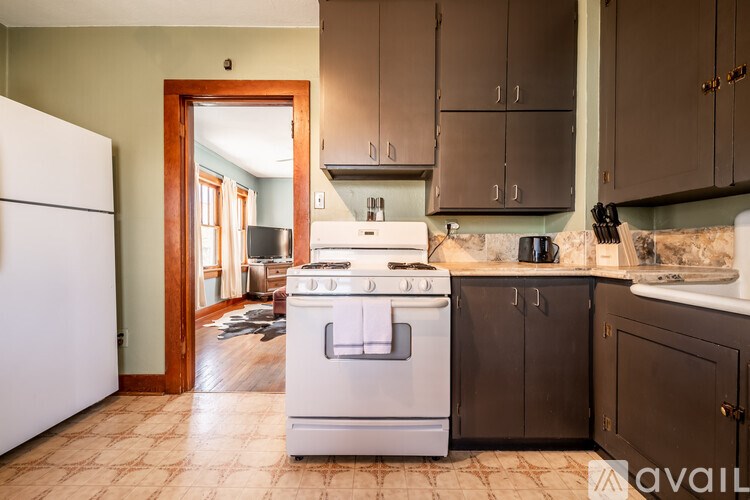 A kitchen with a white fridge and a white stove top oven.