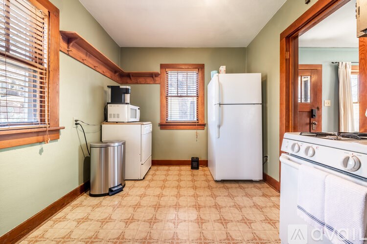 A kitchen with a white refrigerator, a white stove, and a white dishwasher.