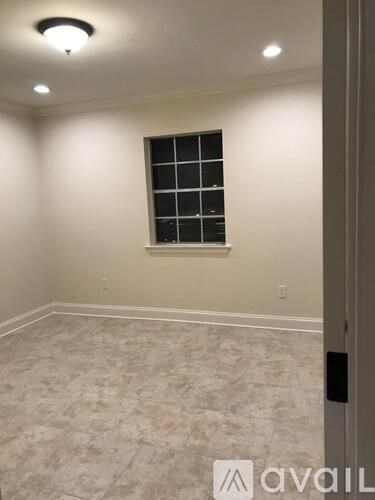 A room with a window and tiled floor.