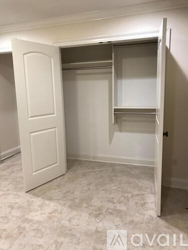 A white door with a glass window is open.