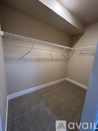 Empty room with grey carpet and white walls.