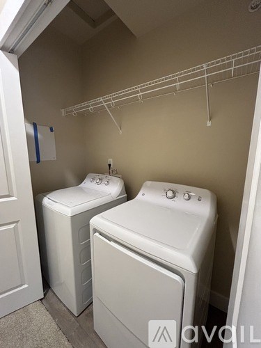 A small laundry room with a washer and dryer.