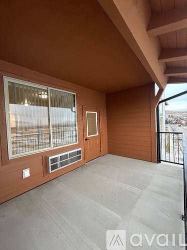 A balcony with a window and a door.