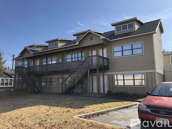 A house with a car parked in front.