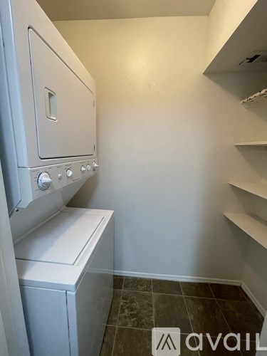 A white oven and dryer in a small room.