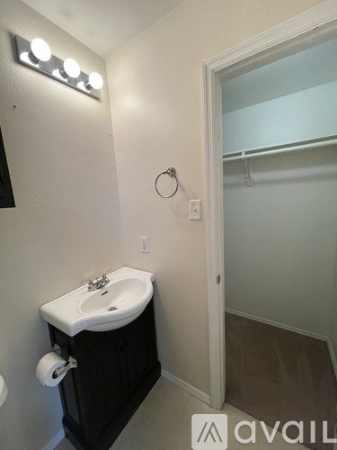 A bathroom with a sink and mirror.