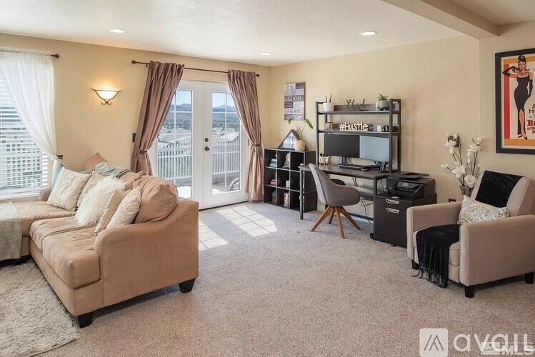 A living room with a couch, chair, and television.