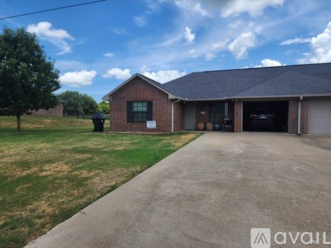 A house with a garage and a driveway in front.