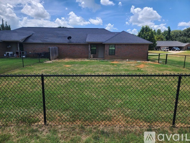 A house with a black fence in front of it.