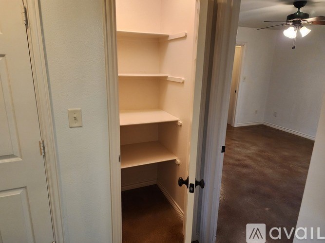 Empty room with a doorway leading to another room.