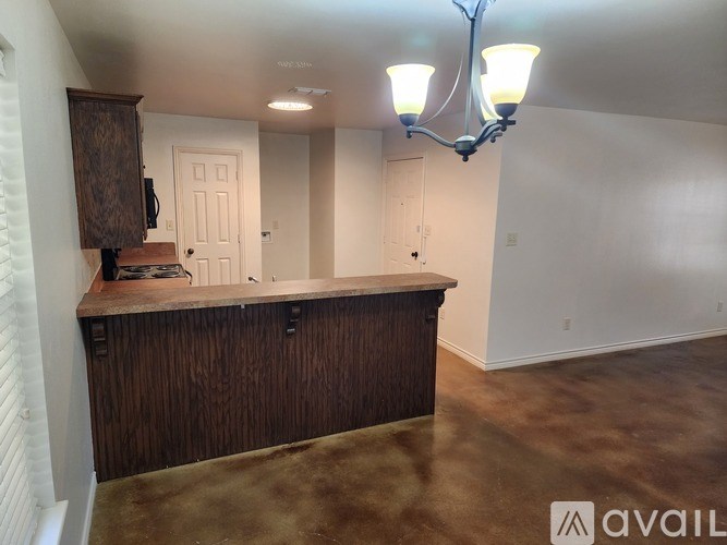 A room with a wooden bar and a chandelier.