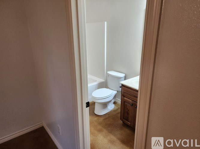 A white toilet in a small bathroom.