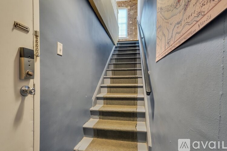 A staircase with a map on the wall.