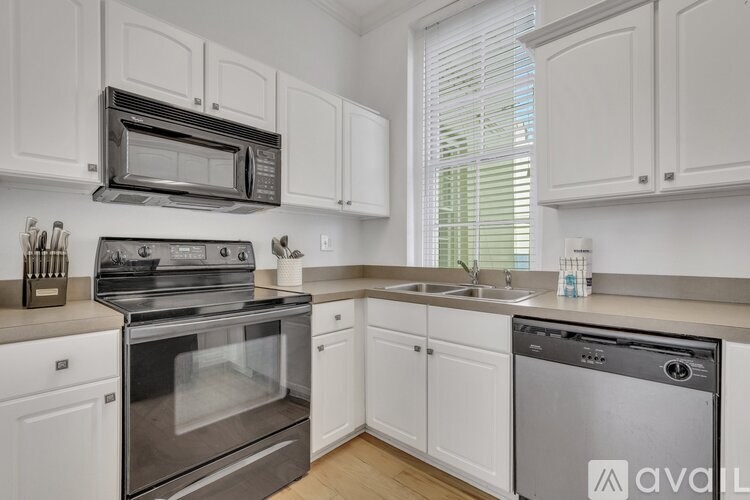 A kitchen with white cabinets and stainless steel appliances.