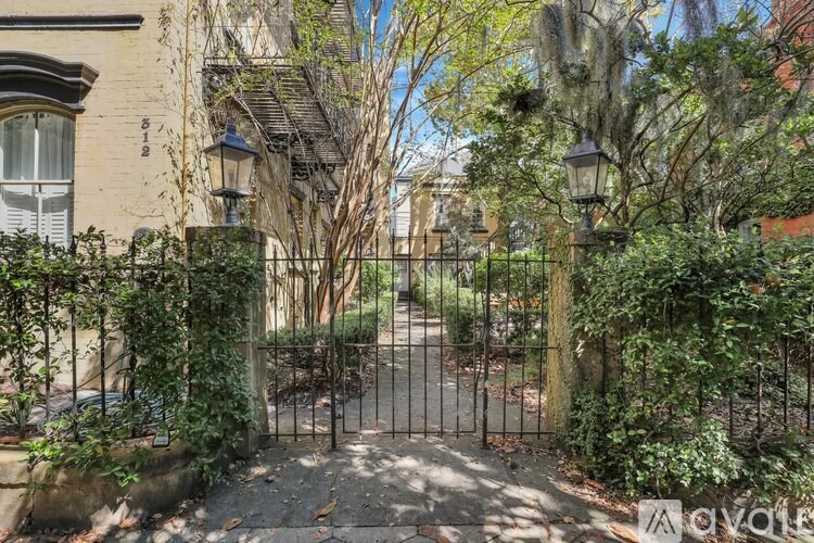 A gated entrance to a lush green area.