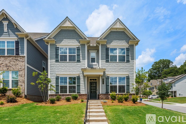 A house with a front yard and a clear sky above.