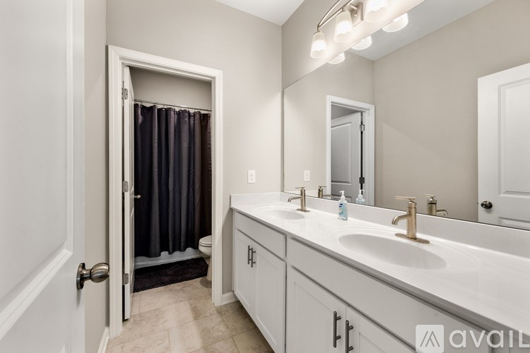A bathroom with a white sink and a white door.