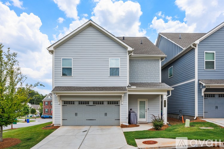 A two-story house with a garage is shown in the image.
