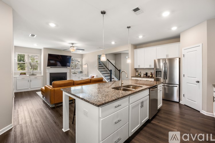 A modern kitchen with white cabinets and a central island.