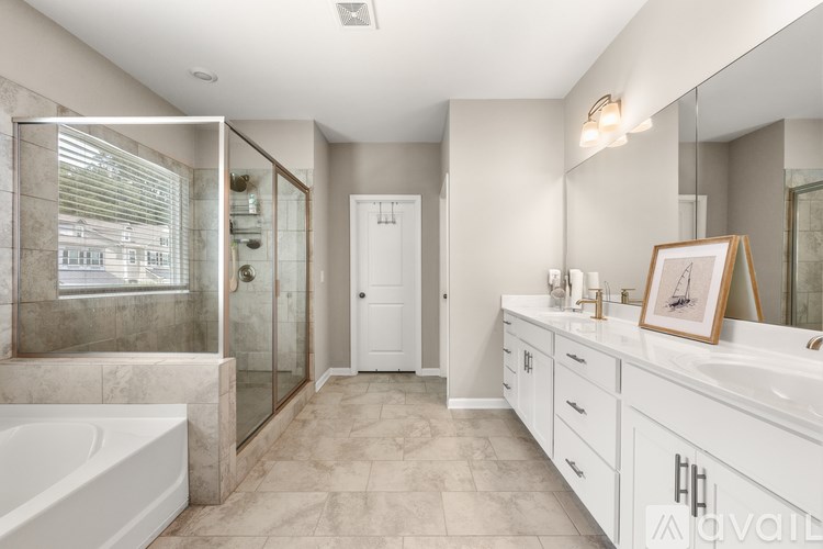 A bathroom with a white tub, sink, and vanity.