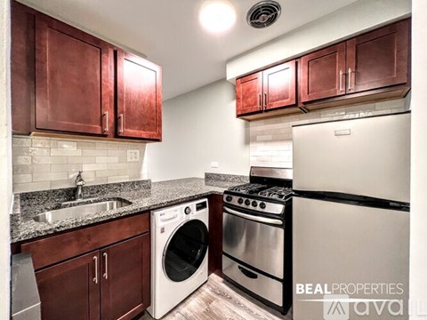 A kitchen with brown cabinets and a white fridge.