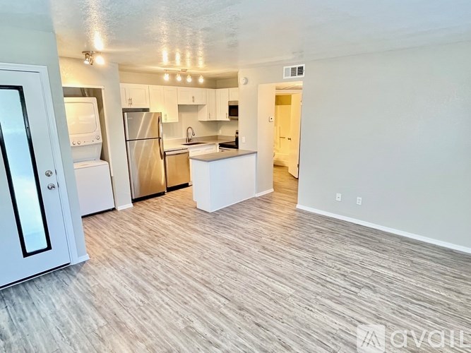 A kitchen with white appliances and a white door.