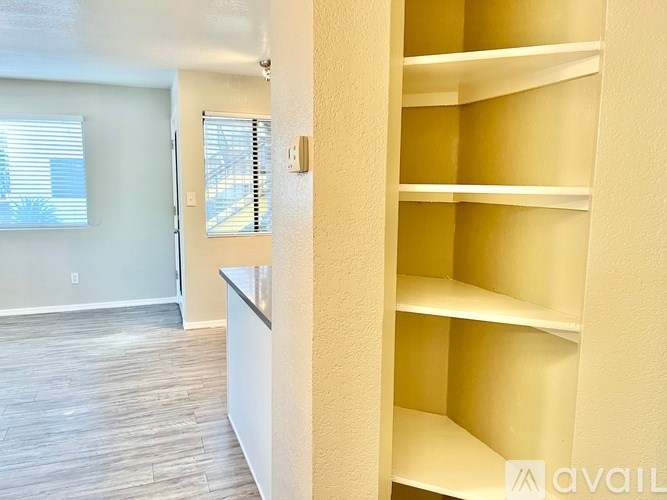 Empty shelves in a room with a window.