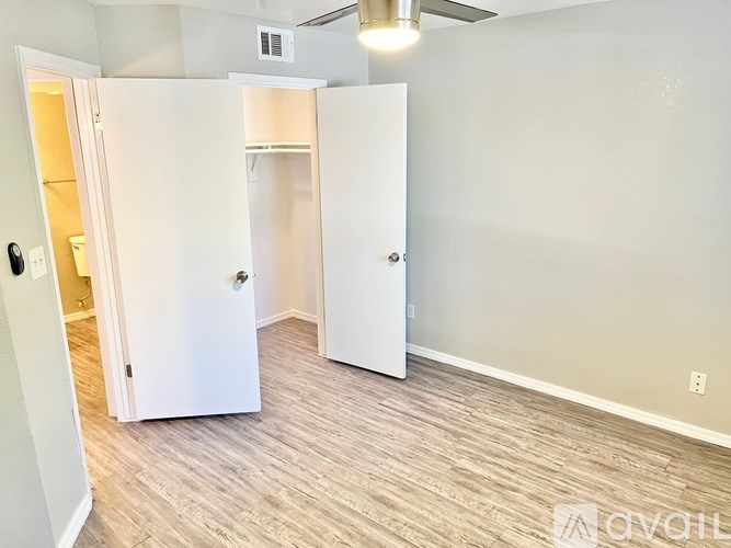 A room with a white door and a white wall.