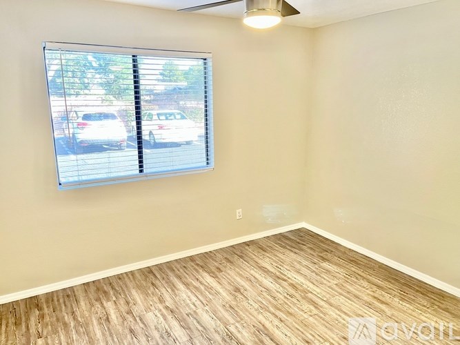 A room with a window and a ceiling fan.