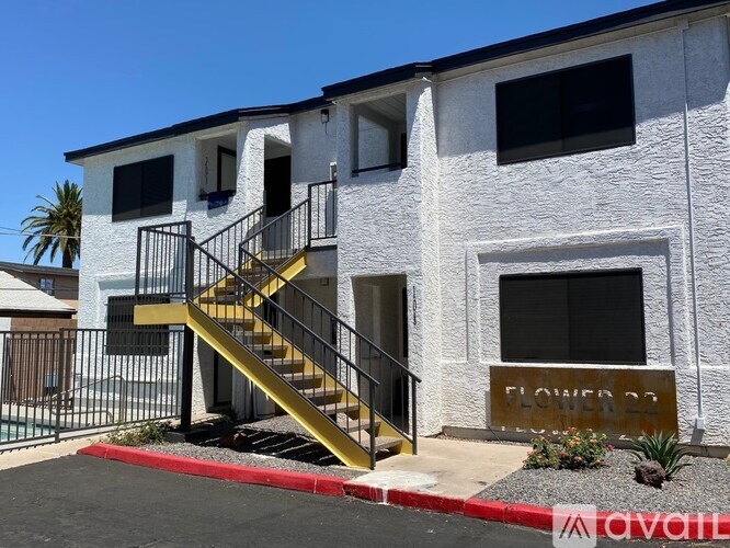 A white building with a sign that says "Flower Dr." on it.
