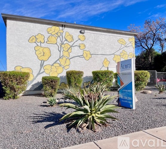 A mural of yellow flowers is painted on a white wall.