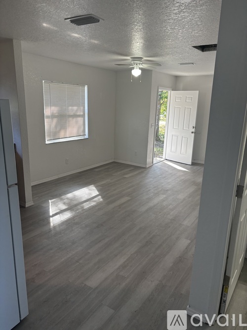 A room with a light grey floor and white walls.