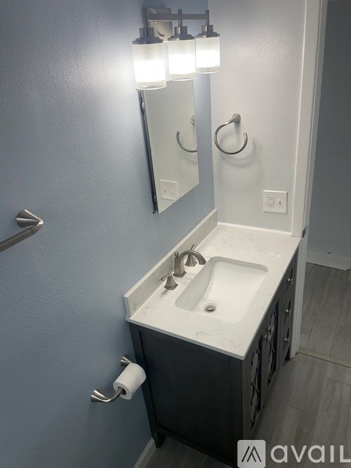 A bathroom with a sink and mirror.