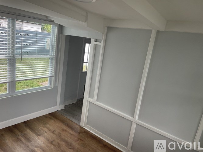 A room with a window and a door.