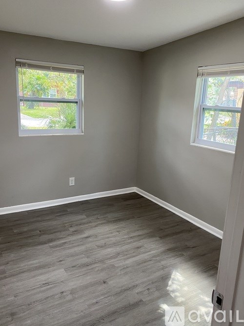 A room with grey walls and a wooden floor.