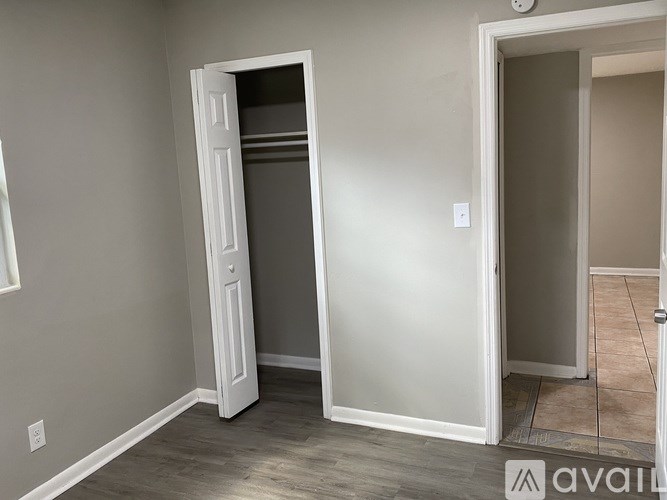 A room with a white door and a window.