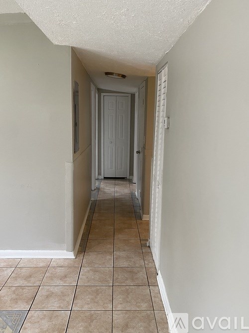 A hallway with a door at the end.
