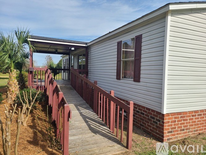 A house with a red fence and a covered walkway.