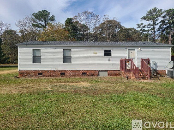 A house with a grey siding and a red staircase.