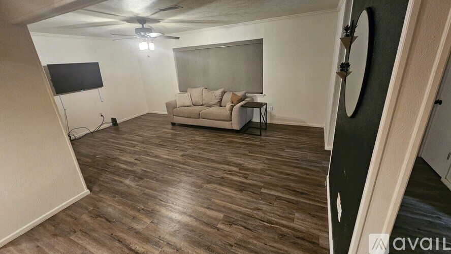 A living room with a couch and a television.