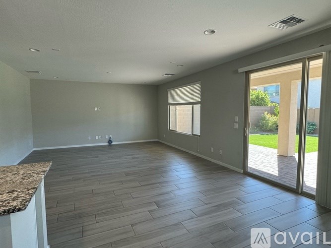 A spacious room with wooden flooring and a marble countertop.