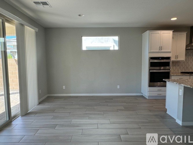 A kitchen area with a countertop and cabinets is available for rent.