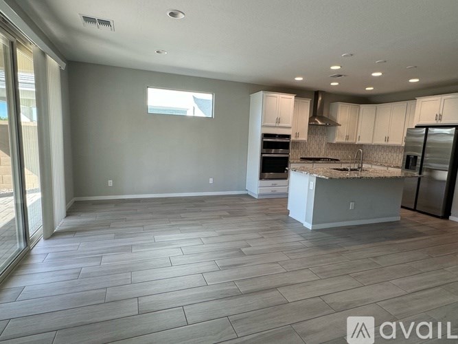 A spacious kitchen with a large island and stainless steel appliances.